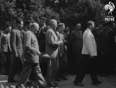 a black and white photo of a group of men with the words pathe at the top