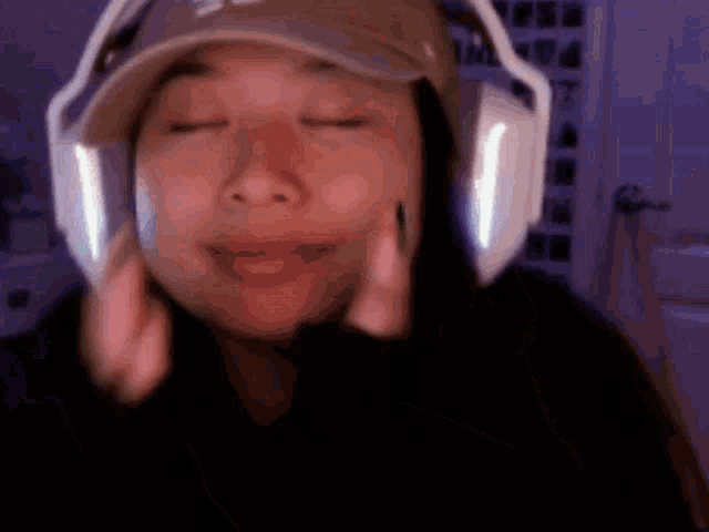 a woman wearing headphones and a hat with a s on it