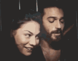 a man and a woman are looking at each other .