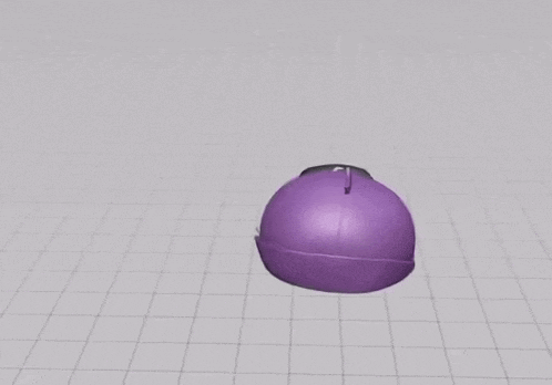 a purple ball is sitting on top of a grid on a table .