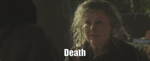 a woman in a dark room with the word death behind her