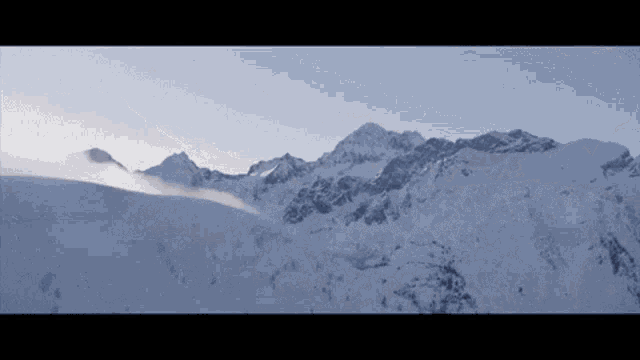a snow covered mountain with a blue sky behind it