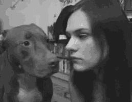 a woman and a dog are looking at each other