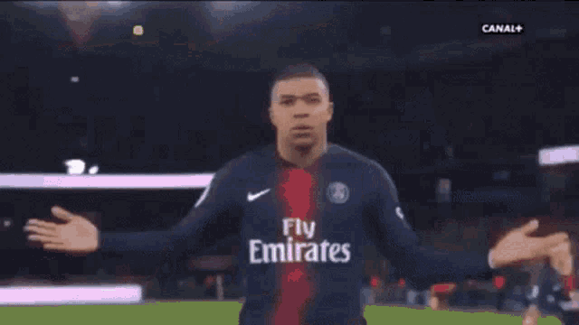 a man in a paris saint-germain jersey is being held by another man