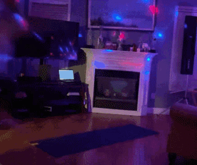 a living room with a fireplace and a blue yoga mat