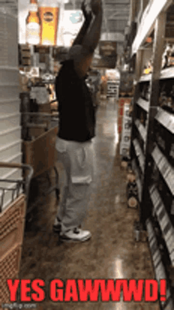 a man standing in a grocery store with his arms in the air and the words yes gawwwd on the bottom