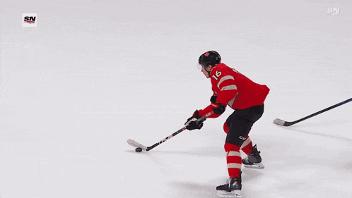 a hockey goalie in a yellow jersey with the number 32 on the back