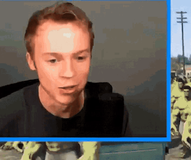a man in a black shirt is looking at something in a video