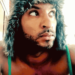 a man wearing a furry hat and a green bra
