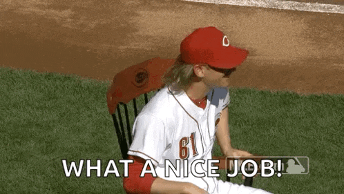 a baseball player is sitting in a chair on the field and saying what a nice job