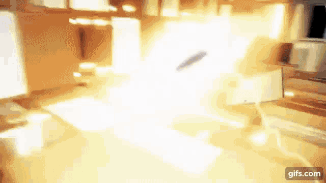 a blurred image of a room with a light coming out of the window