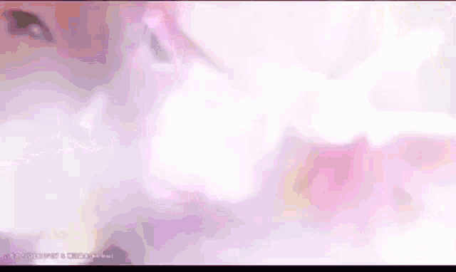 a girl is singing into a microphone in a pink background .