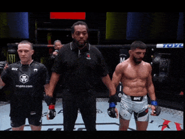 a man in a ufc shirt is standing next to another man