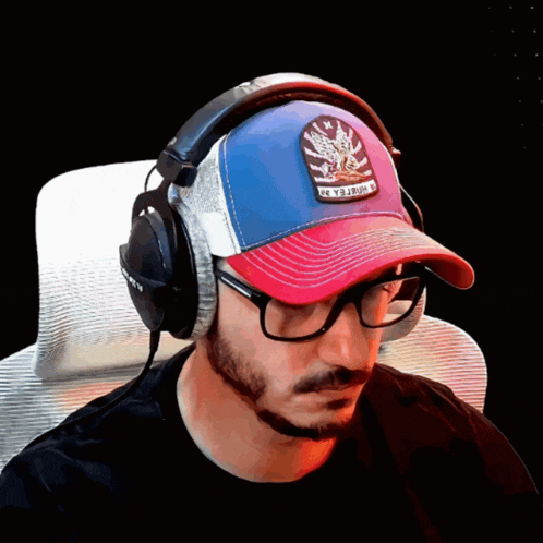 a man wearing headphones and a baseball cap that says freedom