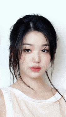 a woman with long black hair is wearing a white top