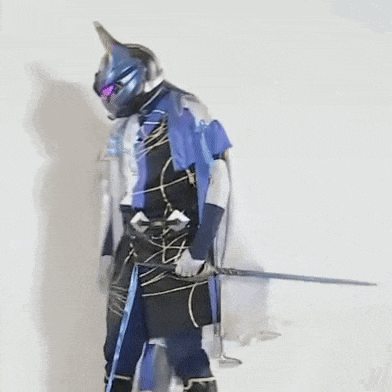 a man in a blue and black costume is holding a sword in his hand .