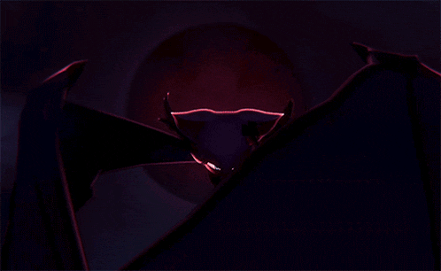 a bat with wings is flying in front of a red moon