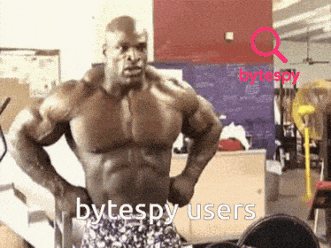a muscular man is standing in a gym with his hands on his hips and the words bytespy users written on the bottom