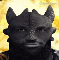 a man with a beard and horns is wearing a dragon costume .