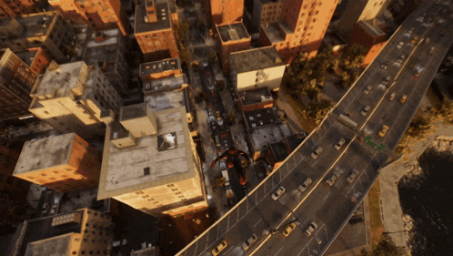 an aerial view of a city shows a busy highway and buildings