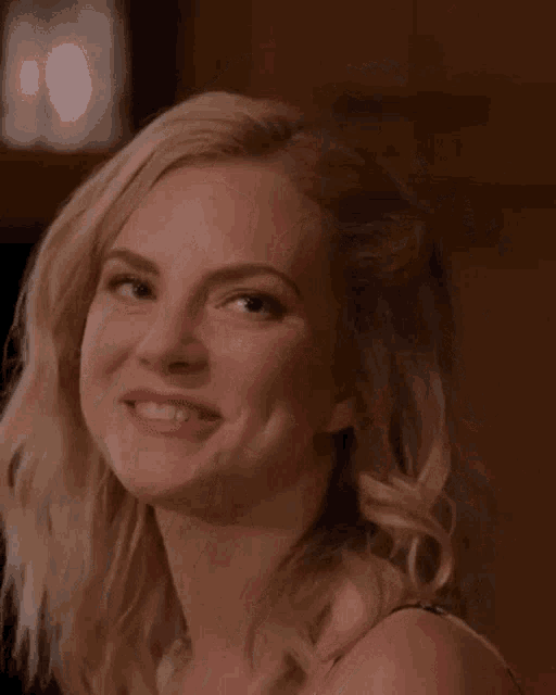 a close up of a woman 's face smiling with her mouth open