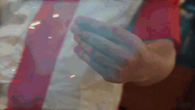 a close up of a person 's hand holding something in their hand