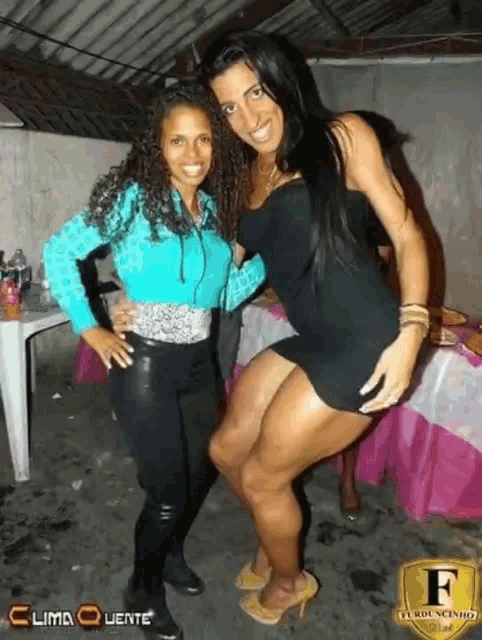 two women posing for a photo with the letter f on the bottom