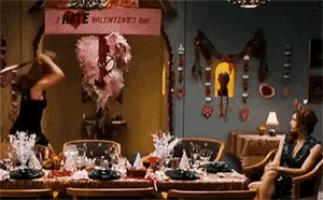 a valentine 's day sign hangs above a dining table
