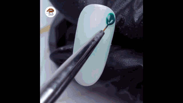 a close up of a nail with a brush on it