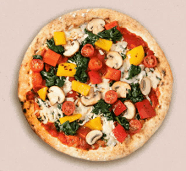 a pizza with mushrooms tomatoes spinach and peppers on it