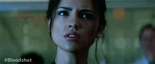 a close up of a woman 's face with the hashtag #bloodshot visible