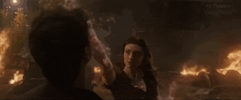 a man and a woman are standing next to each other in a fire .