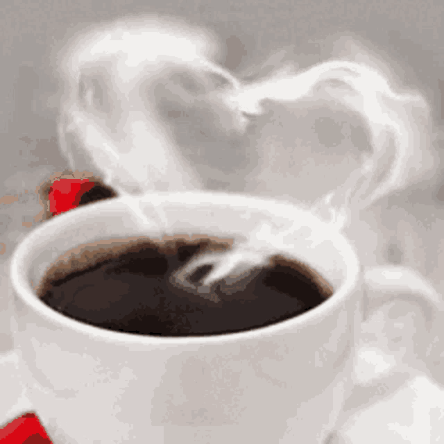 a cup of coffee with smoke in the shape of a heart