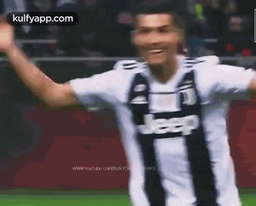 a soccer player wearing a jeep jersey is celebrating a goal on a soccer field .