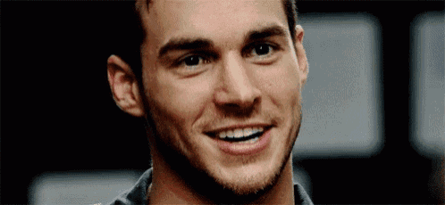a close up of a man 's face with a smile on his face .