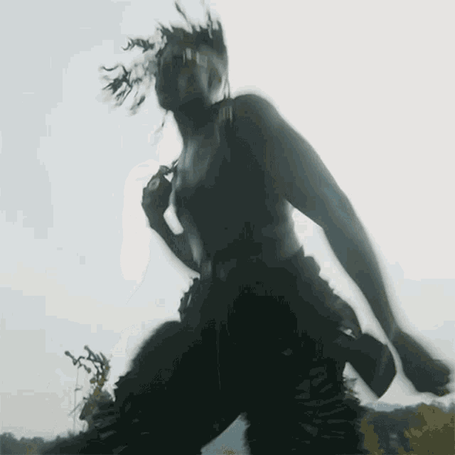 a blurred image of a person dancing with a gun