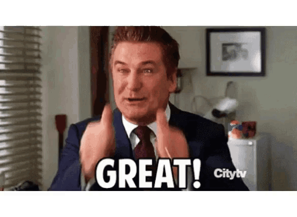 a man in a suit and tie is making a great gesture with his hands .