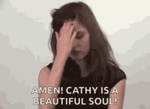 a woman is covering her face with her hand and says amen ! cathy is a beautiful soul .