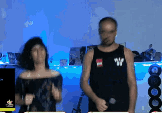a man and a woman are dancing in front of a screen that says showtime