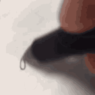 a close up of a person 's hand holding a pen and writing on a piece of paper .