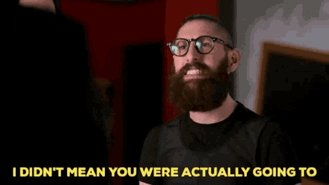 a man with a beard and glasses says " i didn t mean you were actually going to "