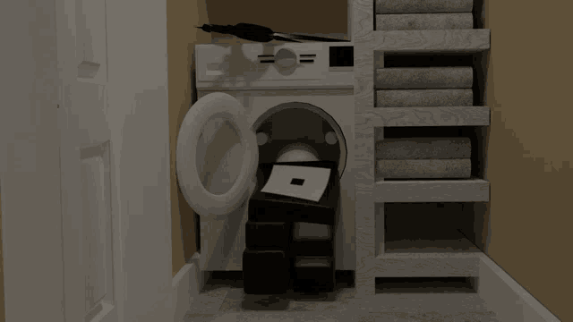 a washer and dryer in a closet with a stack of towels behind it