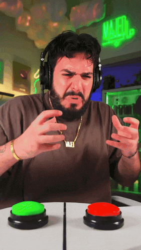 a man wearing headphones and a necklace with a name tag that says majed