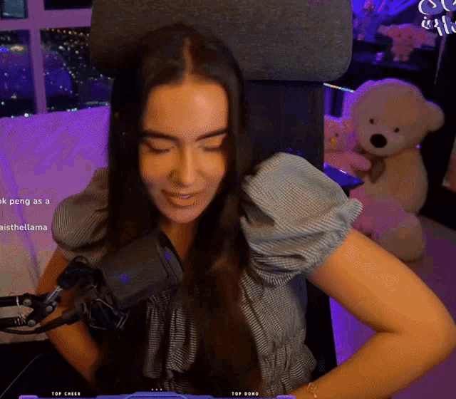 a woman is sitting in a chair with a teddy bear in the background and the words top cheer on the bottom