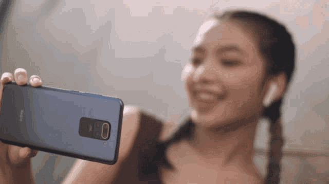 a woman is taking a selfie with her phone that says redmi