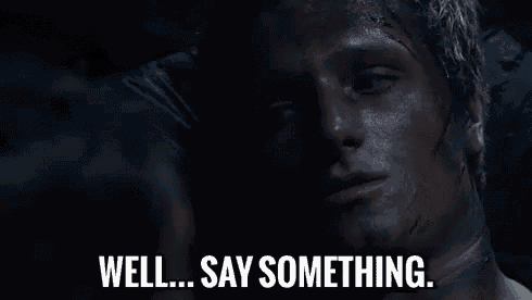 a close up of a man 's face with the words `` well ... say something '' written next to him .