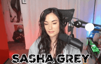 a woman sitting in front of a microphone with the name sasha grey written on the bottom