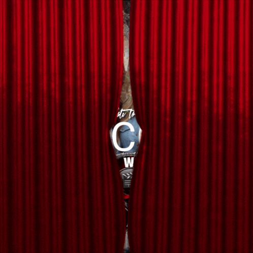 two women behind a red curtain with the word welcon on it