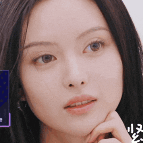 a close up of a woman 's face with chinese writing on the bottom left