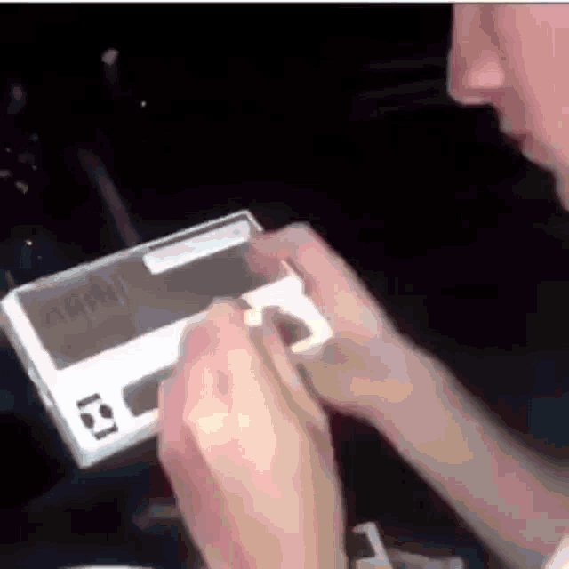 a person is holding a box with a sticker on it that says ' i 'm sorry ' on it .